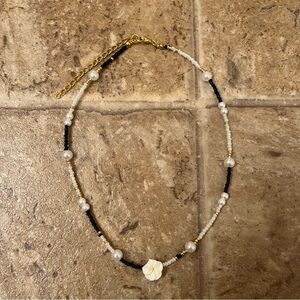 Black and white plumeria flower necklace
